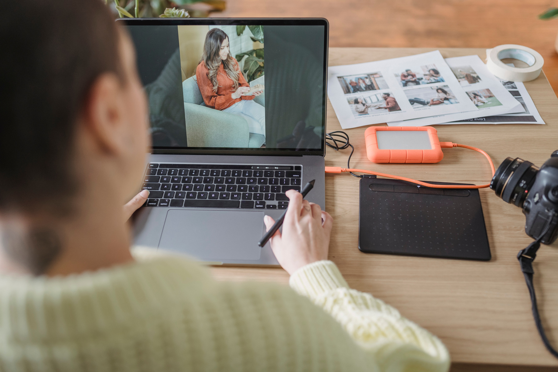 Anonymous woman editing photo on laptop